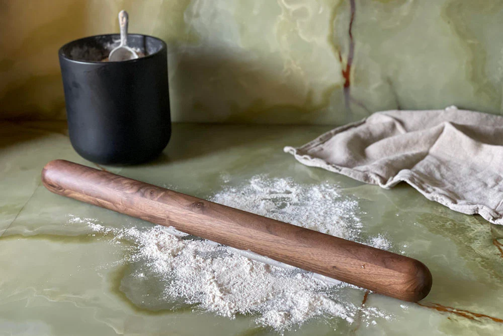 Wooden baking and weekend cooking tools arranged on a kitchen surface